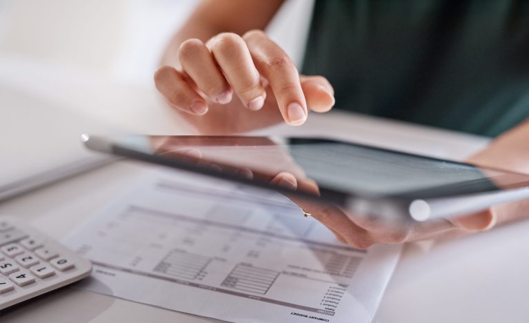 Person using a tablet with architectural plans or drawings